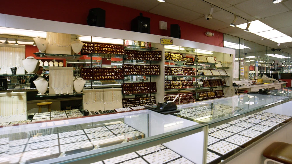 Inside Salermo Jewelers with gold jewelry and glass display counters
